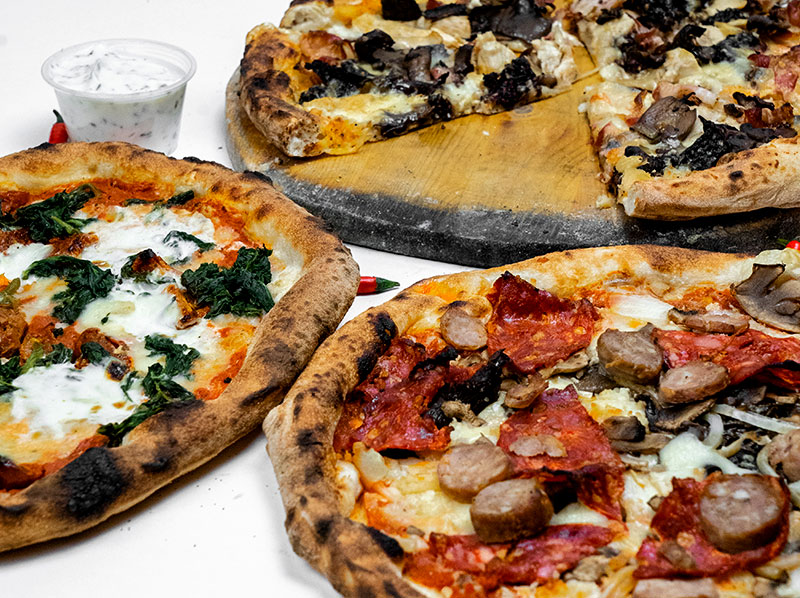 Three Italian pizzas on plates